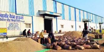 Pile-up of paddy at procurement centers due to slow processing pace, causing difficulties for farmers.