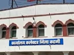 Katni Collector Dilip Yadav signs suspension order while officers observe