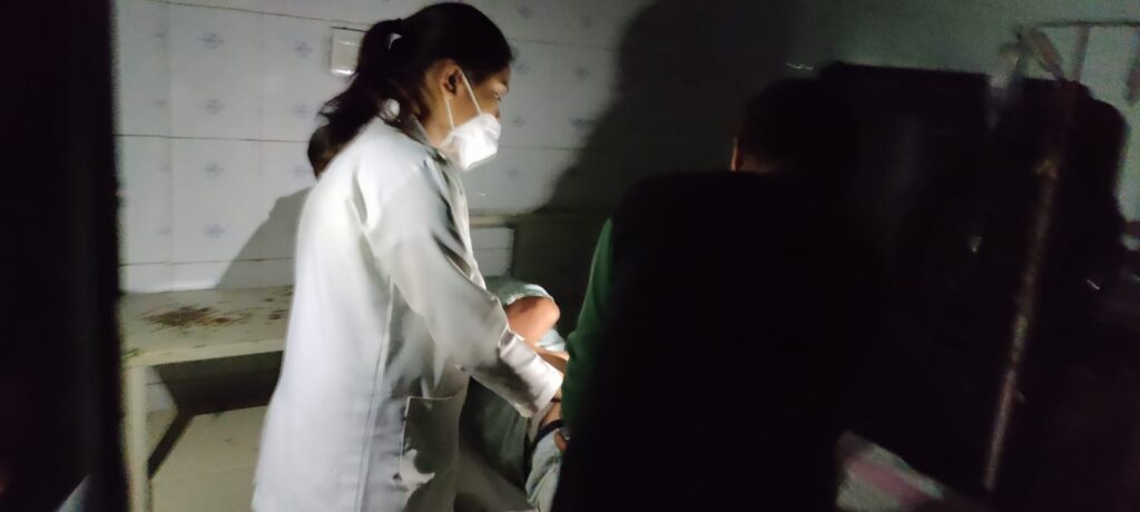 Doctors examining patients using mobile torchlight during 4-hour power outage at Naugaon Civil Hospital, Chhatarpur