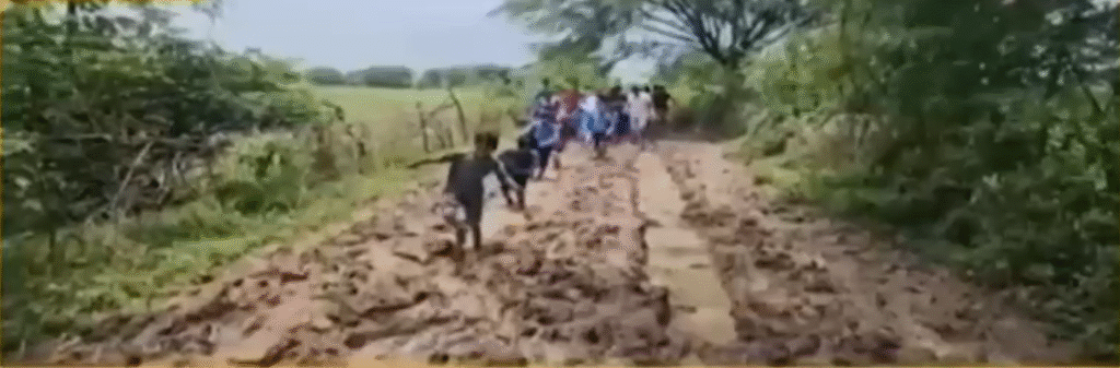 Children walking through mud in Damoh.