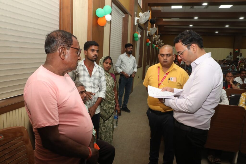 Katni Collector Ashish Tiwari listening to an elderly disabled man during public hearing and ensuring quick action on land dispute.